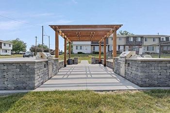 Outdoor kitchen with pergola & grilling stations